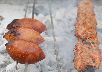 icli Kofte aka Kibbeh and Adana Kebab cooking on Grill at The Taste of Adana Festival in Adana, Turkey