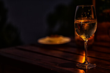 a glass of cold white wine and serving in the restaurant