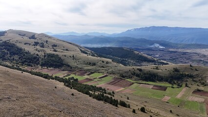Aerial drone footage of the Abruzzo mountains in Italy, featuring dramatic peaks, rolling hills, and breathtaking natural landscapes