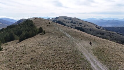 Aerial drone footage of the Abruzzo mountains in Italy, featuring dramatic peaks, rolling hills, and breathtaking natural landscapes