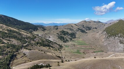 Aerial drone footage of the Abruzzo mountains in Italy, featuring dramatic peaks, rolling hills, and breathtaking natural landscapes