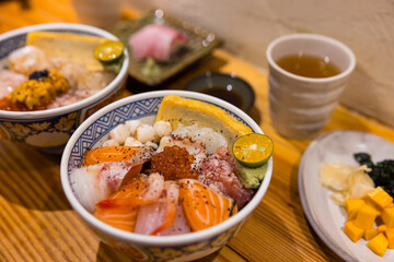 Japanese sashimi rice bowl with salmon shrimp scallop roe