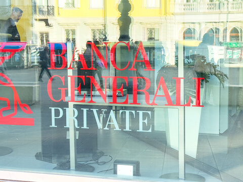 Trieste, Italy - October 14, 2025: Banca Generali Private bank storefront window showcasing modern architecture and vibrant branding in an urban setting with reflections of city life