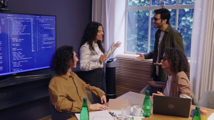 Group of diverse business people In a vibrant team meeting taking place at a modern office, advanced coding techniques are displayed, fosters collaboration and giving hi five and clap - Powered by Adobe