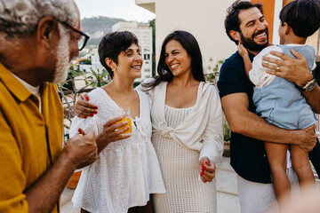 Smiling family enjoying a Brazilian churrasco together on a sunny day