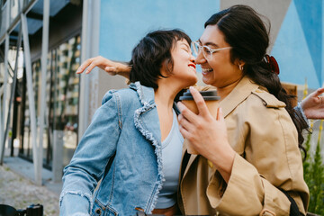 Friends meeting and embracing in the city.