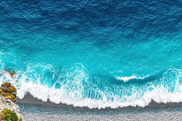 Aerial view of a rocky coast with turquoise ocean waves