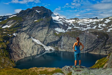 Naklejka premium Hiker Overlooking a Mountain Lake
