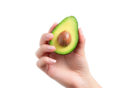 Fresh avocado half with seed held by hand showing healthy fruit and natural texture in close up