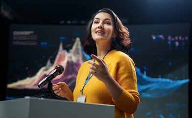 woman is giving a presentation at conference