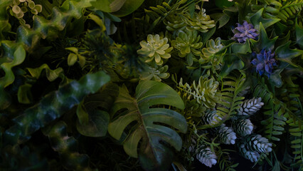 Decorative green wall with mixed artificial plants and succulents