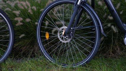 Fototapeta premium Bicycle wheel with disc brake near green grass outdoors