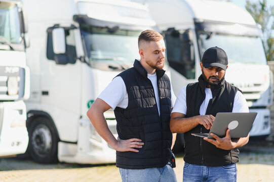 Truck drivers using laptop managing logistics fleet