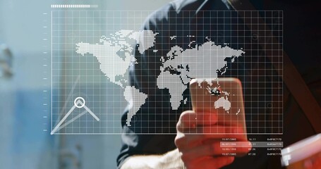 Standing man holding smartphone viewing digital world map overlay with data chart text in office