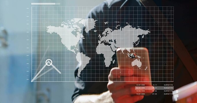 Standing man holding smartphone viewing digital world map overlay with data chart text in office