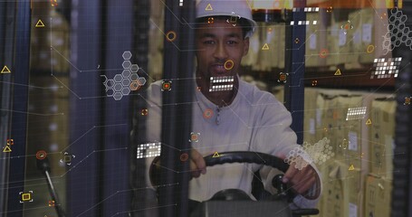 Operating forklift in warehouse, worker wearing hard hat steering among racks with data overlay