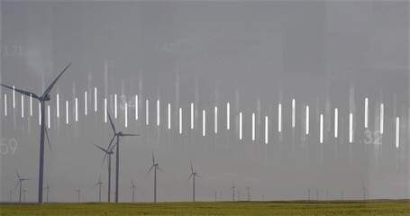 Featuring group of white wind turbines rotating on grassy plain under grey sky, with data overlay
