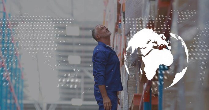 Worker in navy uniform checking boxes on shelves in warehouse aisle, with world map overlay