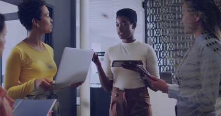 Collaborating four coworkers in business attire sharing ideas in office with laptop and tablets