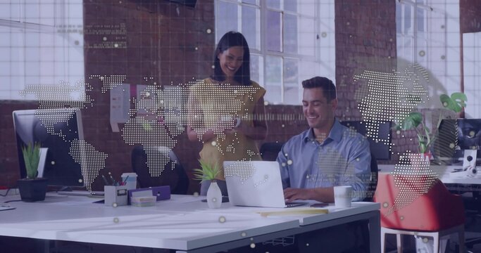 Collaborating staff wearing workwear multitasking on laptop and tablet in office, with map overlay - Powered by Adobe