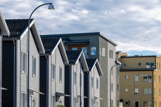 Modern townhouse with wooden facade and large windows in the district of Stora Ursvik Stockholm Sweden showing contemporary residential design