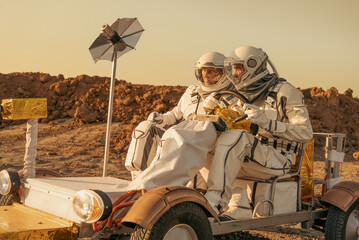 Explorers in space suits operating a Mars rover during planetary research.