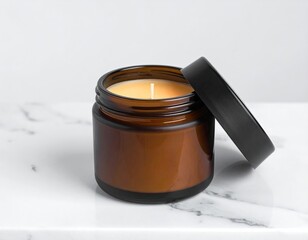 Amber jar candle with black lid, sits on marble