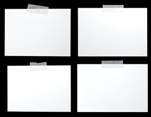 Four blank notes taped onto a dark background