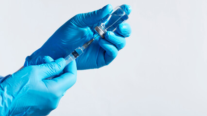 Medical Professional Preparing Syringe with Vial closep with copy space 