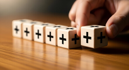 "Stacked wooden blocks with black plus symbols being added — business growth, teamwork and incremental improvement concept"