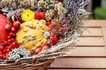 Beautiful autumn background with pumpkins, flowers and plants in a wicker basket. Step by step, tutorial.