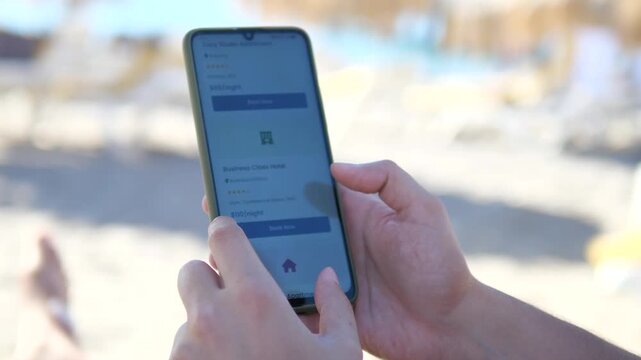 This scene captures the accommodation search process with hands interacting with a rental app, selecting interesting listings and reading descriptions while enjoying coastal environment. Excellent for