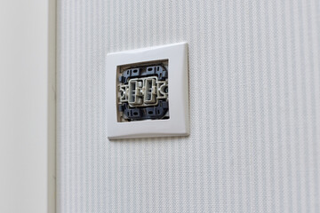 unfinished electrical switch installation on wall at home, close-up