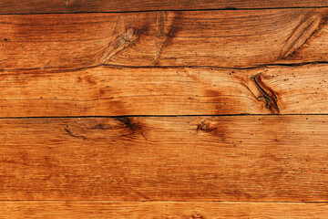 Naklejka premium Old natural dark wood planks showing intricate grain patterns and knots, creating a rustic and organic surface texture