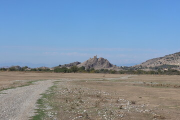 hemite castle dominating a rocky hill landscape. historic amouda castle fortification on arid hill