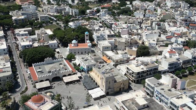 Aerial view of the city center bustling with life, showcasing buildings with distinct architectural styles, Kos, Greece.
