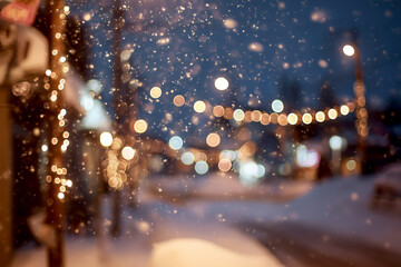 Falling snow creating bokeh festive christmas lights