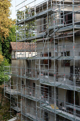 Scaffolding covers a historic building in Mont de Marsan, indicating a restoration project. Workers are likely busy repairing and maintaining the structure, enhancing its beauty.