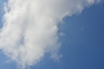 Beautiful and bright unusual nature, gentle autumn blue sky with light white clouds, big cloud, bright sun rays, sunny weather.