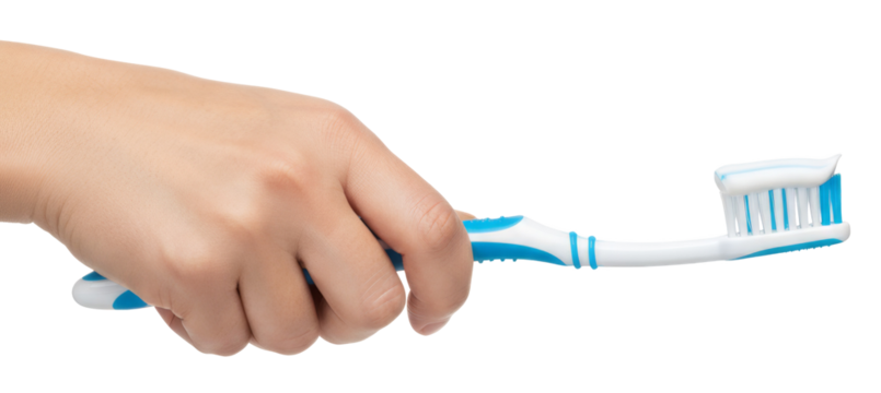 hand holding a blue toothbrush with toothpaste applied on the bristles