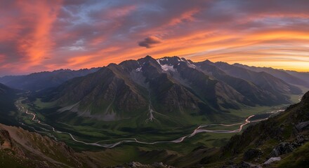 Wide, vibrant sunset over a mountain range, a valley with a winding river, and colorful sky