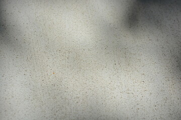 Construction and renovation work, plastering load-bearing street walls in sunlight. The white walls are coated with rough street primer with long micro-cracks throughout the surface and background.