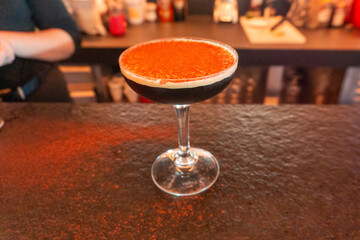 Espresso martini cocktail with cocoa powder on bar counter