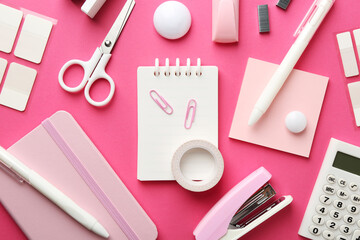 Stapler and other stationery on pink background, flat lay