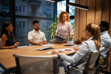 Diverse business team collaborating in modern office meeting