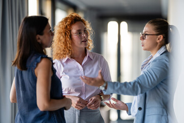 Businesswomen engaged in serious workplace conversation indoors