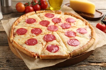 Delicious pepperoni pizza on wooden table, closeup