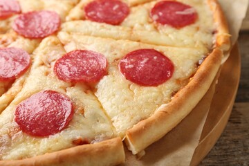 Delicious pepperoni pizza on wooden table, closeup