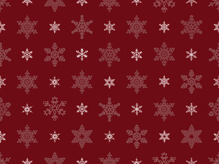 Seamless pattern of white snowflakes of various sizes and intricate designs, against a solid red background.
