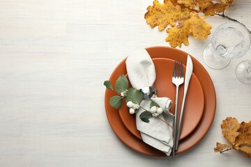 Beautiful table setting with autumn decor on white wooden background, flat lay. Space for text